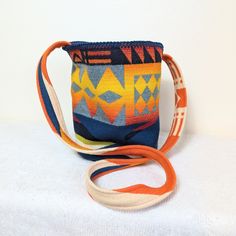 Vibrant repurposed wool blanket woven in the Pacific Northwest with a patchwork lining created from contemporary fabric.  Bag measures 7.5" in diameter and is 10" high.  The strap measures 48" from the top of one side of the bag to the top of the opposite side for a comfortable cross-body fit. Artisan Bucket Bag With Adjustable Strap, Daily Use Bucket Bag With Weaving, Contemporary Fabric, The Pacific Northwest, Woven Blanket, Fabric Bag, Wool Blanket, The Pacific, Body Fit