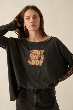 Mineral washed graphic t-shirt. Vintage-style "But She's Hot" text print with flame graphics. Long sleeves with flame print. Dropped shoulder. Round neckline. Center-back seam. Oversized fit. 100% Cotton. Imported top designed and printed in LA. Model wears size S. Flame Graphics, Text Print, Vintage Canvas, Vintage Prints, Oversized Fits, Round Neckline, Vintage Style, Graphic T Shirt, Tops Designs