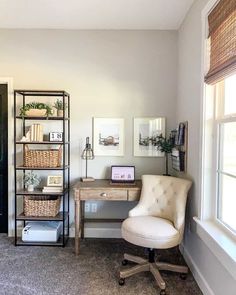 a room with a chair, desk and bookshelf in front of a window