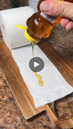 someone is pouring honey onto a roll of paper