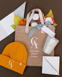 the contents of a bag are laid out on top of each other, including an orange beanie