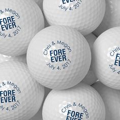 many white golf balls with blue lettering on them