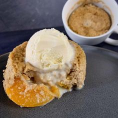 an ice cream sundae on a plate next to a cup of coffee