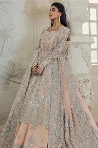 a woman in a silver and pink lehenga