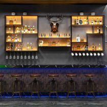 an image of a bar with liquor bottles and deer head mounted to the back wall