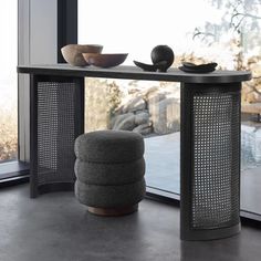 a table that has some bowls on it next to a window with a glass door