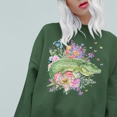 Sweatshirt with Floral Alligator: Shirt for Animal Lover | Funny Cottagecore Crocodile Sweatshirt, Kitschy Eclectic Aesthetic Gift for Her -------- Sweatshirt: Floral Alligator Retro Inspired Sweatshirt Loose Fitting Sweatshirt Runs True to Size 50% Cotton, 50% Polyester Shirt Brand: Gildan 18000 -------- SIZING: Width x Length x Sleeve Length (Inches) S: 20 x 27 x 20 M: 22.01 x 28 x 21.02  L: 24 x 29 x 22.01 XL: 25.98 x 30 x 22.99 2XL: 28 x 31 x 24.02 3XL: 30 x 32 x 25 4XL: 32 x 32.99 x 26.02 5 Casual Green Dinosaur Print Tops, Casual Green Tops With Dinosaur Print, Green Dinosaur Print Tops For Spring, Green Dinosaur Print Top For Spring, Funny Cottagecore, Eclectic Aesthetic, Spring Nights, Aesthetic Gift, Polyester Shirt