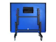 a blue wall mounted to the side of a metal frame with wheels on each side