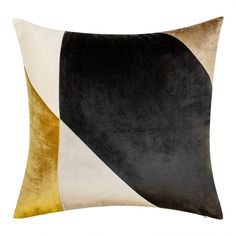 a black, white and gold pillow on a white background