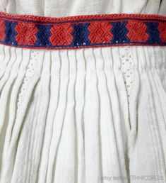 "Discounts available when buying 3 or more items in one shopping trip - please e-mail for a coupon code. Note that international shipping will be less that the posted amount when buying multiple items. Foreign buyers are encouraged to send an e-mail for an exact quote. ITEM DESCRIPTION: One of several Romanian folk costume sets I'm listing today. This one includes a linen blouse and skirt with red and blue geometric embroidery. Blouse collar fastens with string ties. The front of the skirt is de Folk Style Cotton Dress With Traditional Patterns, Cotton Dresses With Embroidered Border For Festivals, Traditional White Linen Dress, Cotton Dress With Embroidered Border For Traditional Ceremonies, Traditional Embroidered Peasant Dress, Peasant Dress With Embroidered Border For Festival, Peasant Style Festival Dress With Embroidered Border, Traditional Embroidered Daywear Dresses, Traditional Cotton Dress With Embroidered Hem