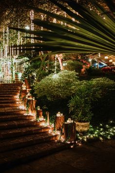 the stairs are lit up with lights and greenery