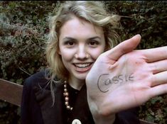 a woman holding up her hand with the word castle written on it in front of her