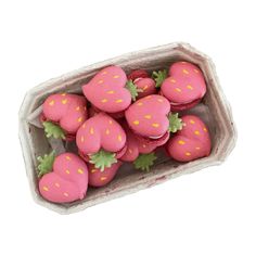 a box filled with lots of pink frosted strawberries