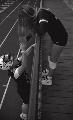 two young children standing next to each other on a track