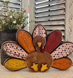 a wooden turkey sitting on top of a table