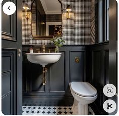 the bathroom is decorated in black and white checkered wallpaper, with gold accents