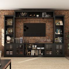 a living room with an entertainment center and brick wall