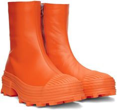 Ankle-high vulcanized LWG-certified buffed calfskin boots in orange. · Round rubber cap toe · Zip closure at inner side · OrthoLite® Recycled™ footbed · Plain-woven lining · Textured rubber midsole · Treaded rubber outsole Supplier color: Bright orange Orange Leather Winter Boots, Yellow Synthetic Round Toe Boots, Orange Combat Boots, Orange Chunky Boots, Orange Ankle Boots, Bright Orange, Luxury Streetwear, Wedge Boot, Rubber Rain Boots