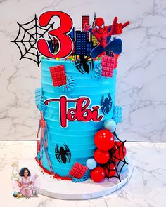 a birthday cake with spiderman decorations on it