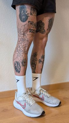 the legs and ankles of a man with tattoos on them