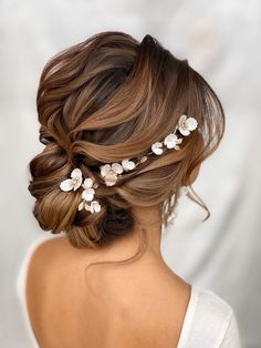 a woman wearing a hair comb with flowers in it