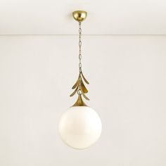 a light fixture hanging from the ceiling in a room with white walls and flooring