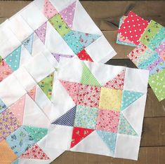 two blocks of colorful fabric sitting on top of a wooden table next to each other