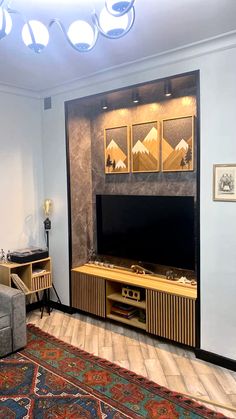 a living room with an entertainment center and rug