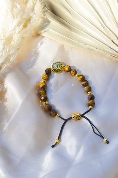 Amplify spiritual and psychic protection, and protect your personal power with our Solar Plexus Chakra Tiger's Eye Energy Protection and Psychic Power Bracelet. The Solar Plexus Chakra, also known as the Manipura Chakra, is in the pit of the abdomen, above the navel. It is responsible for personal strength and will; it is where the essence of confidence andidentity is embedded. When the Solar Plexus Chakra is awakened, the energy flows freely, clearing any self-doubt and insecurity, kindling int Sacred Geometry Jewelry, Manipura Chakra, Power Bracelet, Energy Protection, Lotus Jewelry, Wrist Mala, Aromatherapy Jewelry, Psychic Protection, Aromatherapy Blends