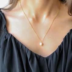 This exquisite necklace combines the luxury of 18k gold with the durability of sterling silver. The base of the necklace is crafted from premium 925 sterling silver, ensuring long-lasting quality, while the 18k gold plating adds a layer of rich, warm luster. The necklace features a sleek, modern design that effortlessly enhances any outfit, from casual to elegant. Its smooth, polished finish gives it a radiant glow, making it a perfect accessory for both day and night. Whether worn alone or laye Elegant Gold Pendant Charm Necklace, Dainty Gold-plated Necklace With Pearl Pendant, Dainty Gold Plated Necklace With Pearl Pendant, Gold-plated Necklaces With Pearl Drop, Classic Gold Charm Necklace With Pearl Drop, Classic Gold Pearl Chain Charm Necklaces, Classic Gold Charm Necklace With Pearl Chain, Elegant Gold-colored Sterling Silver Necklace, Elegant Gold Sterling Silver Necklace