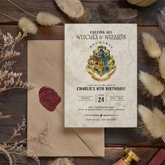 a harry potter themed birthday party with envelope and wax stamp on the table next to it