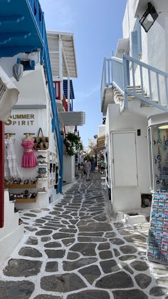 a cobblestone street with shops on both sides