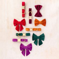 six different colored bow ties laid out on top of each other with gold buckles