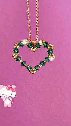 the hello kitty necklace has been made with swarong crystals and is attached to a gold plated chain