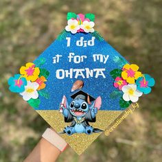 a hand holding up a graduation cap with an image of stitched onto it that says, i did it for my ohana