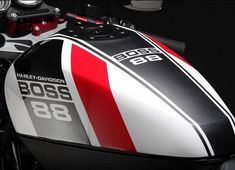 a close up view of the front end of a red, white and black motorcycle