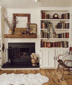 a living room filled with furniture and a fire place next to a bookshelf