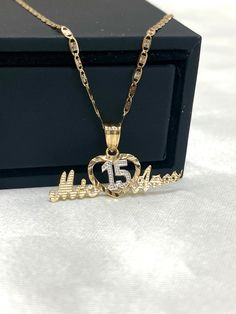 Ioka - 14K Two Tone Gold Sweet 15 Years old Birthday Quinceanera Heart Mis 15 Anos Charm Pendant Necklace with 1.5mm Valentino Chain ✅ PENDANT SPECIFICATIONS:  ➤ Single Sided  ➤ Height: 0.43 in. (11 mm)  ➤ Width: 0.98 in. (25 mm)  ➤ Average Weight: 0.85 gr. ✅ CHAIN SPECIFICATIONS:  ➤ Width: 1.5 mm  ➤ Clasp Type: Spring Ring  ➤ Made with High Quality Metals  ➤ Strong and Secure to hold Pendant charms.  ➤ Fits Into Bale : 2 ✅SHIPPING CONTENTS: ➤14K Gold Chain & Pendant ➤Jewelry Box ✅ PREMIUM 14K GOLD:  Our jewelry is crafted from durable high quality materials, gems, and stones; hand-stamped for authenticity as well as FTC law approved. Unlike cheap costume jewelry, our long lasting jewelry is easy to polish and and won't permanently tarnish or rust! ✅AFTER SALES SERVICES: Limited Lifetime W Quinceanera Jewelry, 15 Necklace, Gold Chain Pendant, Gold Chain With Pendant, Sweet 15, Average Weight, Charm Pendant Necklace, Solid Gold Jewelry, Chain Pendant