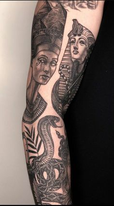 an arm with some tattoos on it and two women in the middle one is holding a snake