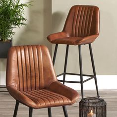 two brown barstools sitting next to each other on top of a wooden floor