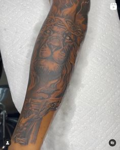 a man's arm with a tiger tattoo on it and a cross in the middle