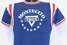 Chest 16 in.  Length 26 in.   Tag Says: No tag  This shirt is a jersey promoting the Montecito Family YMCA in Santa Barbara, California. This jersey was made back in the 50s, and during that decade World YMCA elected their first black president, Charles Dunbar Sherman from Liberia.   Comments: Fits like a modern unisex adult small, feels like rayon, wear around the seams, see pics           JERSEY-127235 Fitted Blue T-shirt For Sports Events, Fitted Graphic Print Jersey T-shirt, Fitted Jersey T-shirt With Graphic Print, Front Print Crew Neck Tops For Sports Events, Crew Neck Tops With Front Print For Sports Events, Retro Blue Sports T-shirt, Retro Jersey Crew Neck Tops, Retro Crew Neck Jersey Tops, Fitted Cotton T-shirt For Sports Events