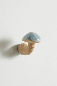 a mushroom shaped object on a white surface