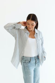 Stay cool and stylish this summer with our Zuma Button Down, featuring pretty iridescent buttons and a raw hem. This super lightweight top offers an effortless, relaxed, and roomy fit, making it perfect for warm weather. Best of all? Its 100% cotton! Wear it buttoned up for a polished look or unbuttoned over a swimsuit or tank for a breezy, casual vibe. This versatile piece is a must have summer staple! Malibu Collection FIT Relaxed Roomy Fit Iridescent Buttons High-Low Raw Hem Clancy is 5'9 Wea Summer Buttoned Tops For Loungewear, Summer Tops With Buttons For Loungewear, Relaxed Fit Shirt With Buttons For Loungewear, Casual Spring Loungewear Blouse, Casual Buttoned Shirt For Loungewear, Casual Loungewear Shirt With Button Closure, Relaxed Blouse For Spring Day Out, Relaxed Spring Blouse For A Day Out, Casual Loungewear Shirt