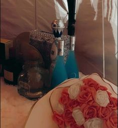 a table topped with vases filled with pink and white flowers