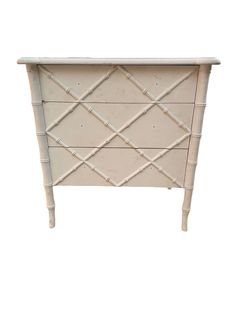 a white dresser with bamboo handles and drawers