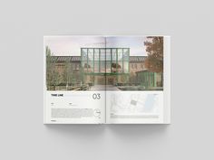 an open book showing the inside pages of a building with glass walls and green roofing