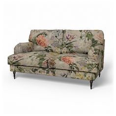 a floral couch sitting on top of a white floor