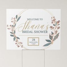 a welcome sign for a bridal shower with flowers and greenery on the front