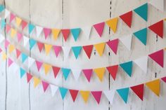 multicolored bunting flags are hanging on the wall